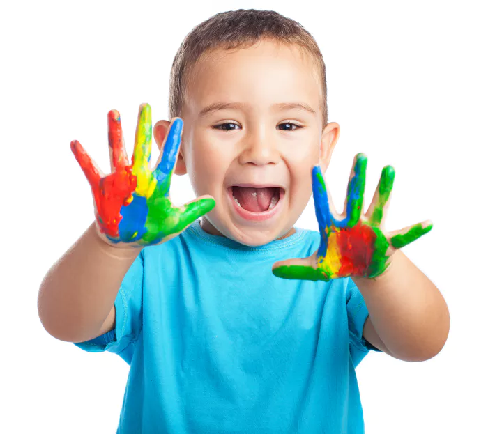 little boy with hands full paint